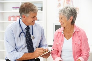 A dentist consulting patient about pill sedation options.